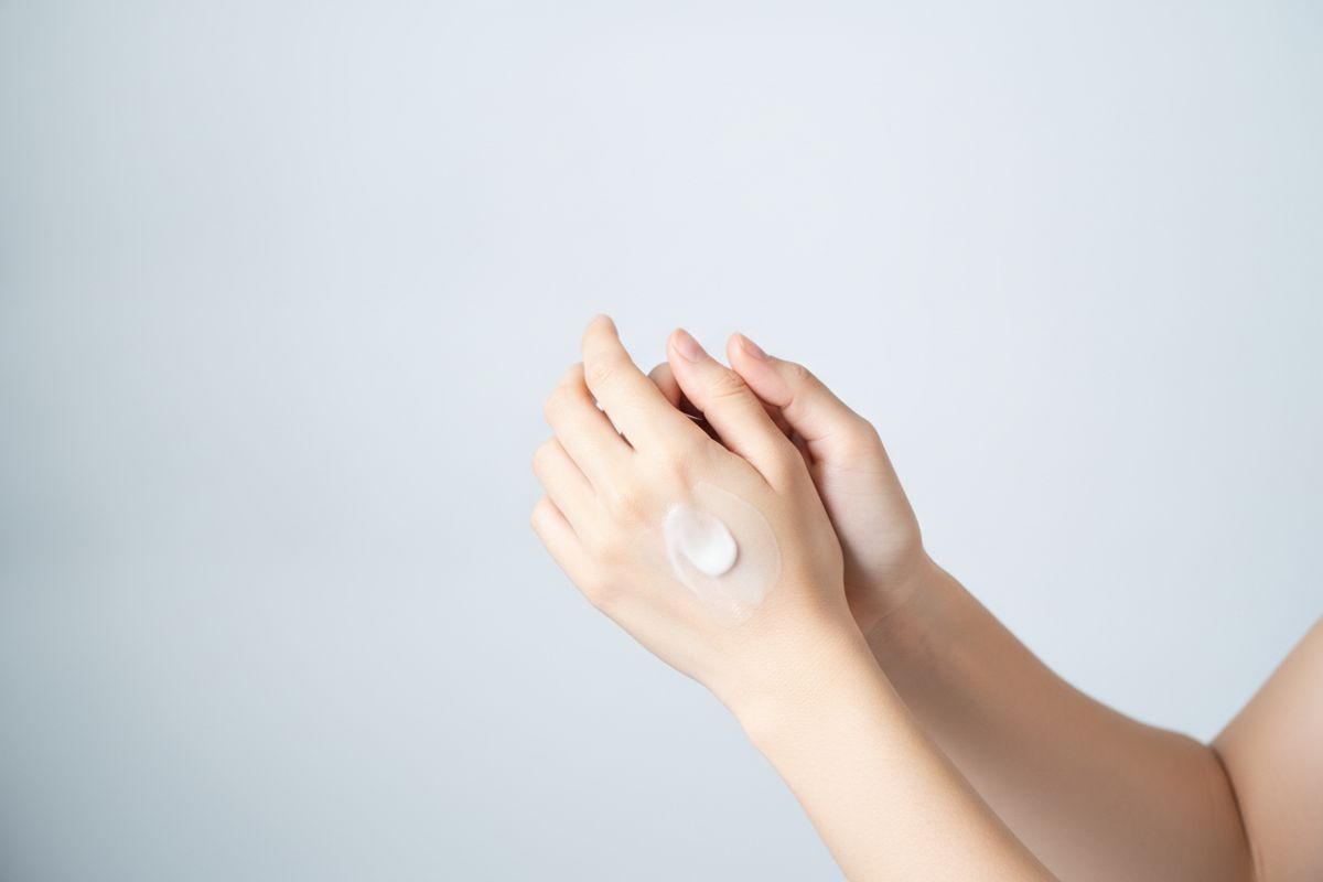 Hands rubbing in lotion